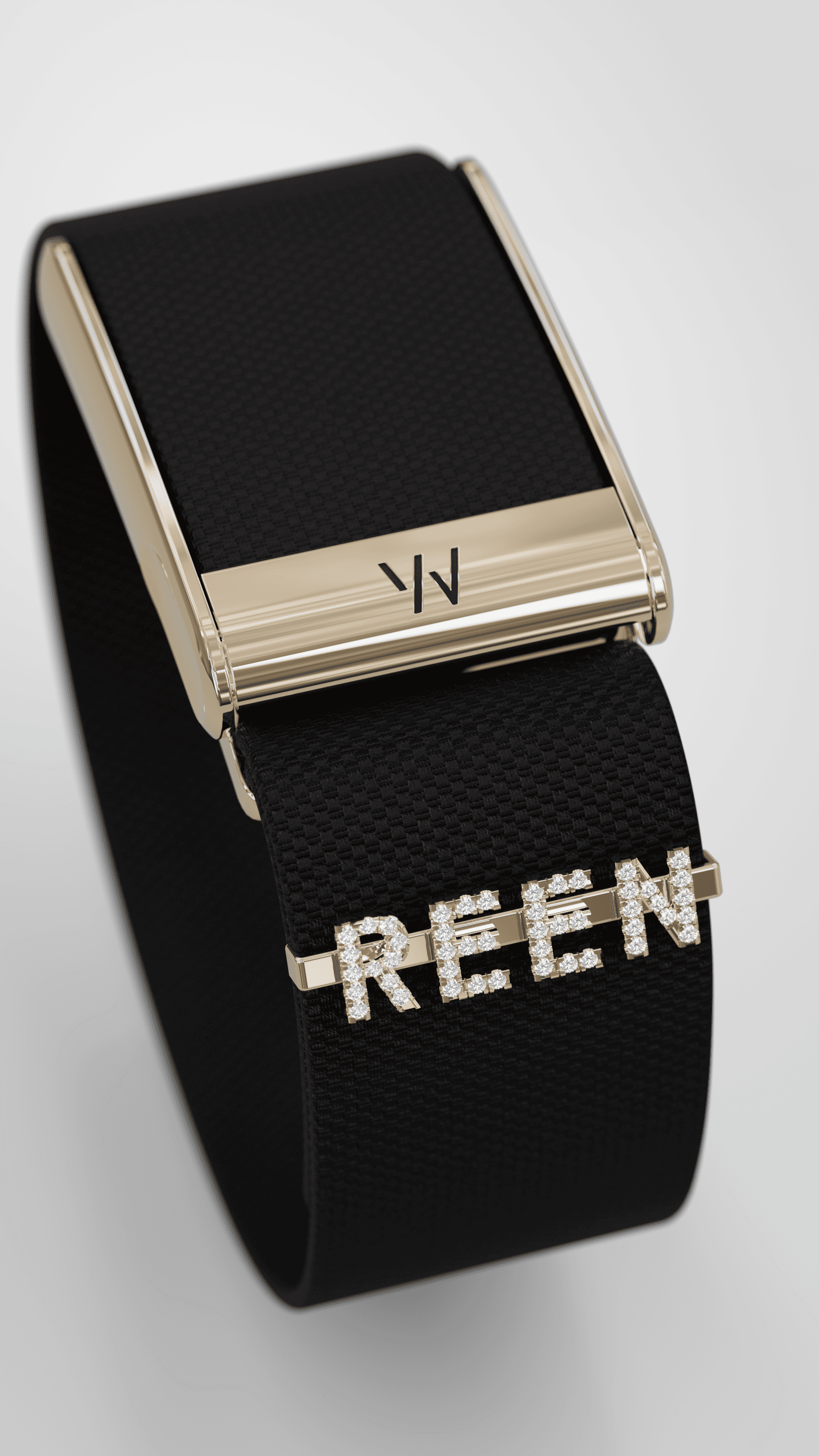 REEN Noir cuff with black woven textile, polished gold hardware, and gem-set lettering