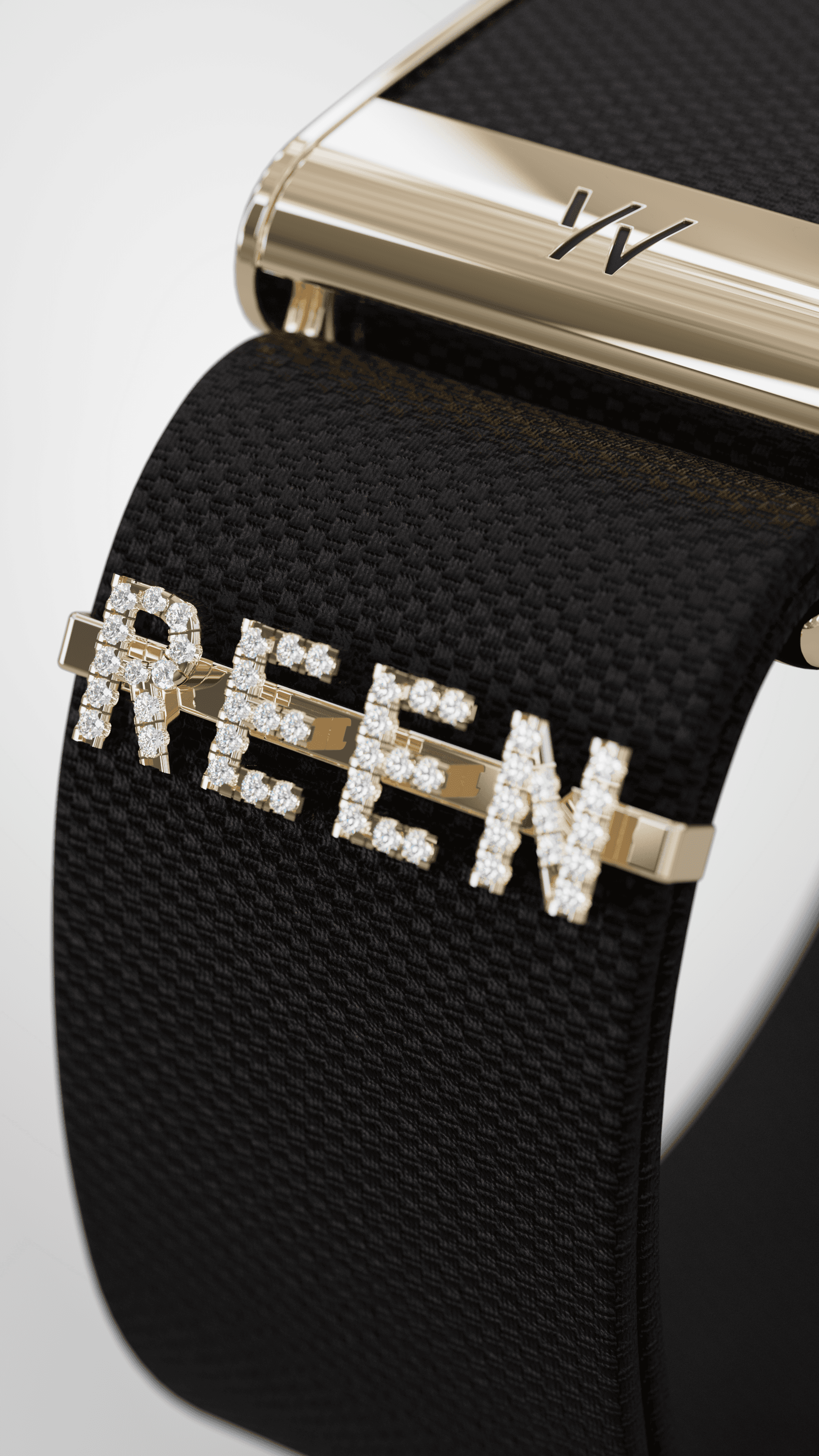Macro detail of REEN Noir gem-set lettering and polished gold hardware